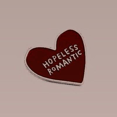 a red heart with the words hopeless romantic written on it