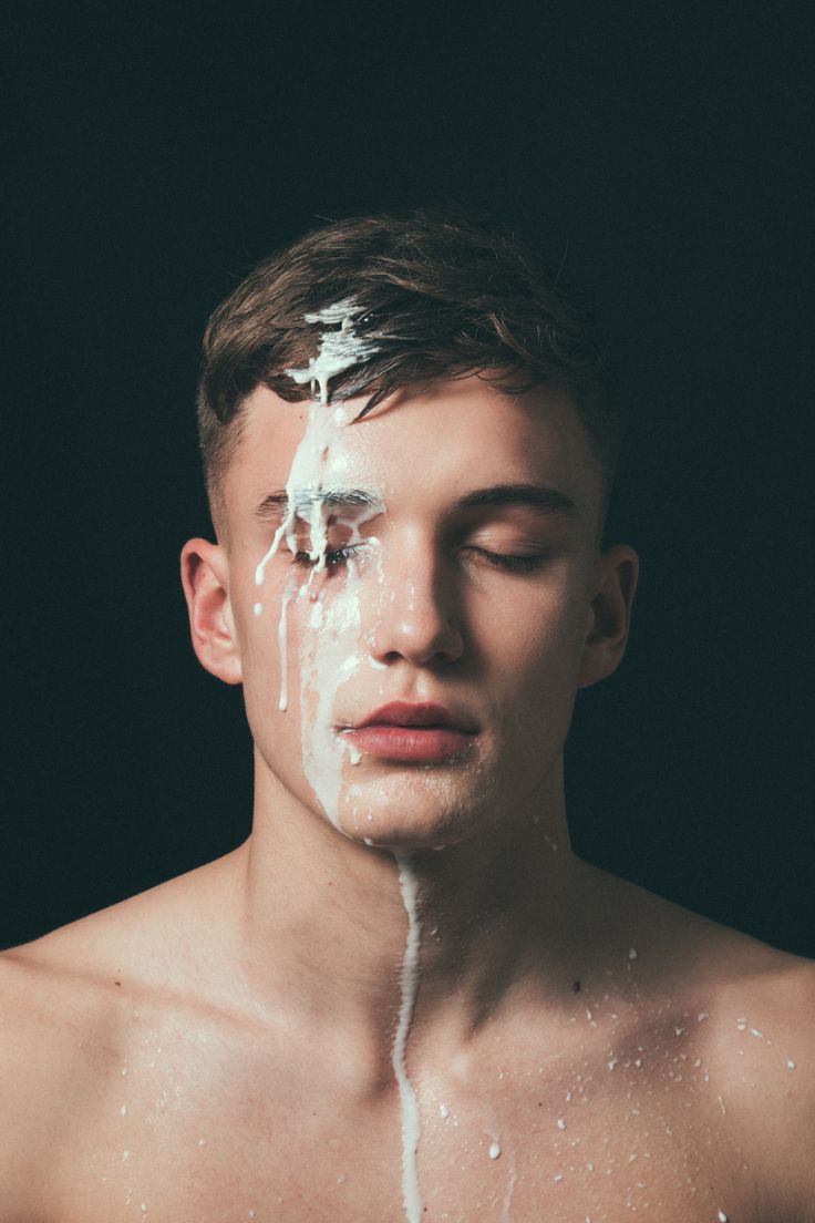 a young man is covered in white cream