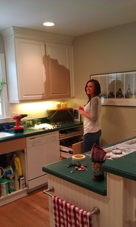 a woman standing in the middle of a kitchen