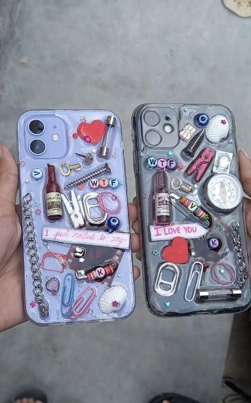 two people holding up their cell phones with various items in them and one has a keychain on it