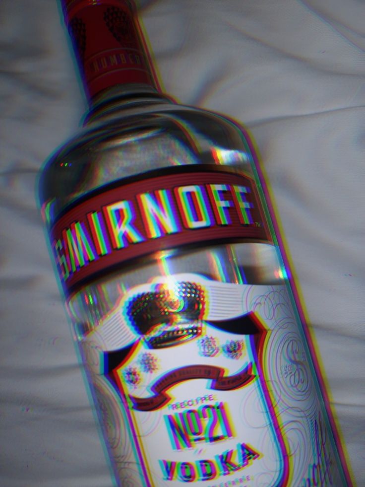 a bottle of vodka sitting on top of a white bed sheet with the word mrnoff printed on it