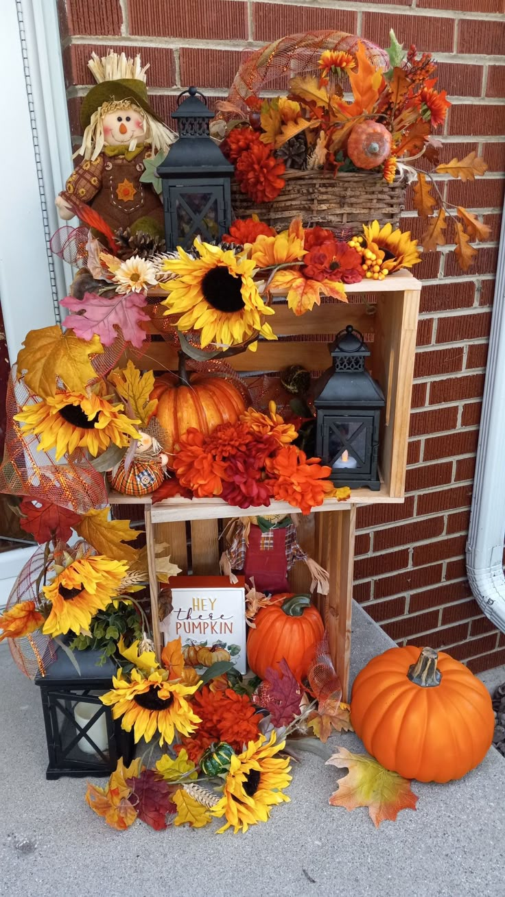 a shelf filled with fake sunflowers and pumpkins