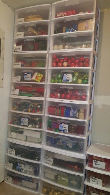 an organized pantry with plastic bins and food in the bottom shelf, along with other containers