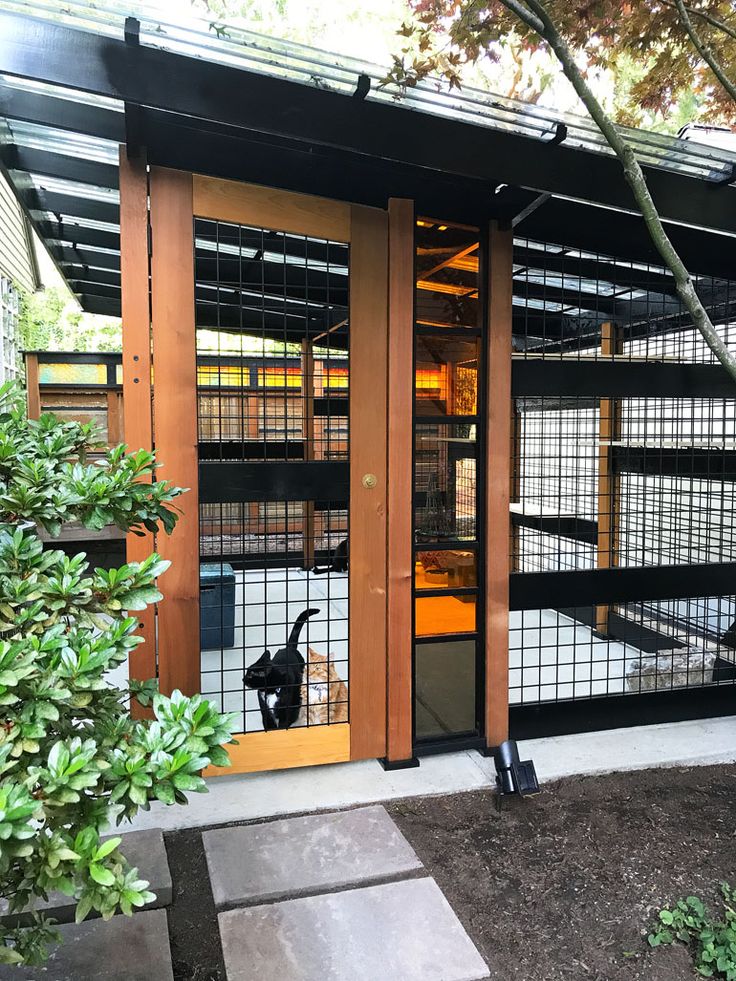 the inside of a building with glass doors and metal mesh coverings on it's sides