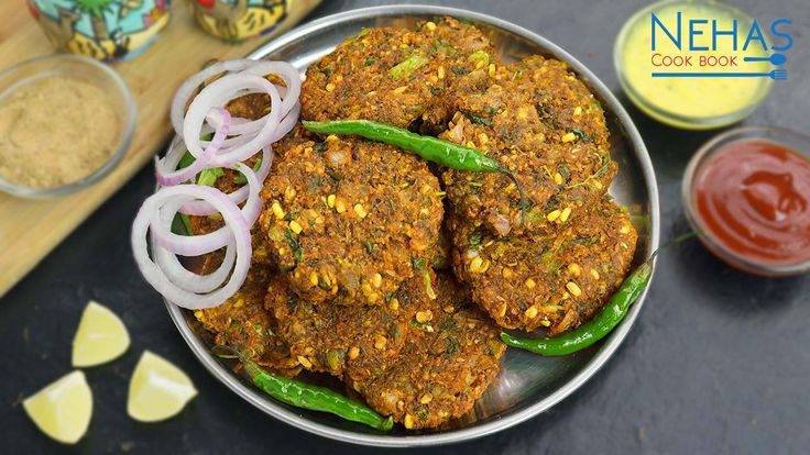 some food is on a metal plate and ready to be eaten with sauces in the background