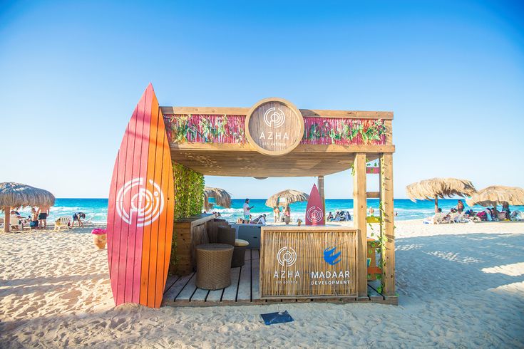 a small bar on the beach with surfboards