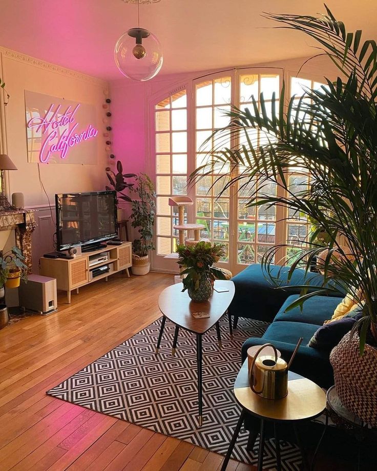 a living room filled with furniture and a large window covered in bright pink light from the windows