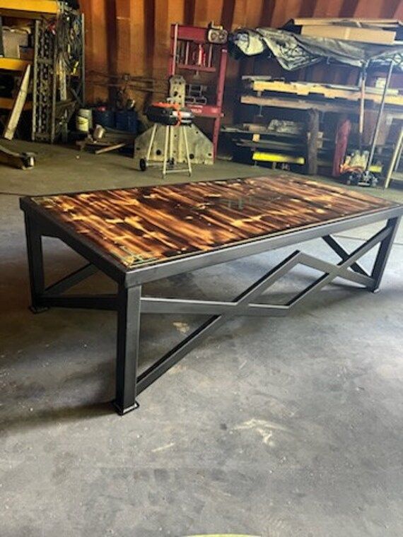 a table made out of wood and metal in a garage