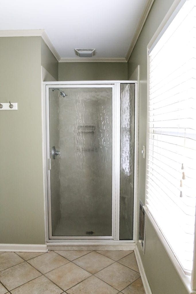 a walk in shower sitting inside of a bathroom