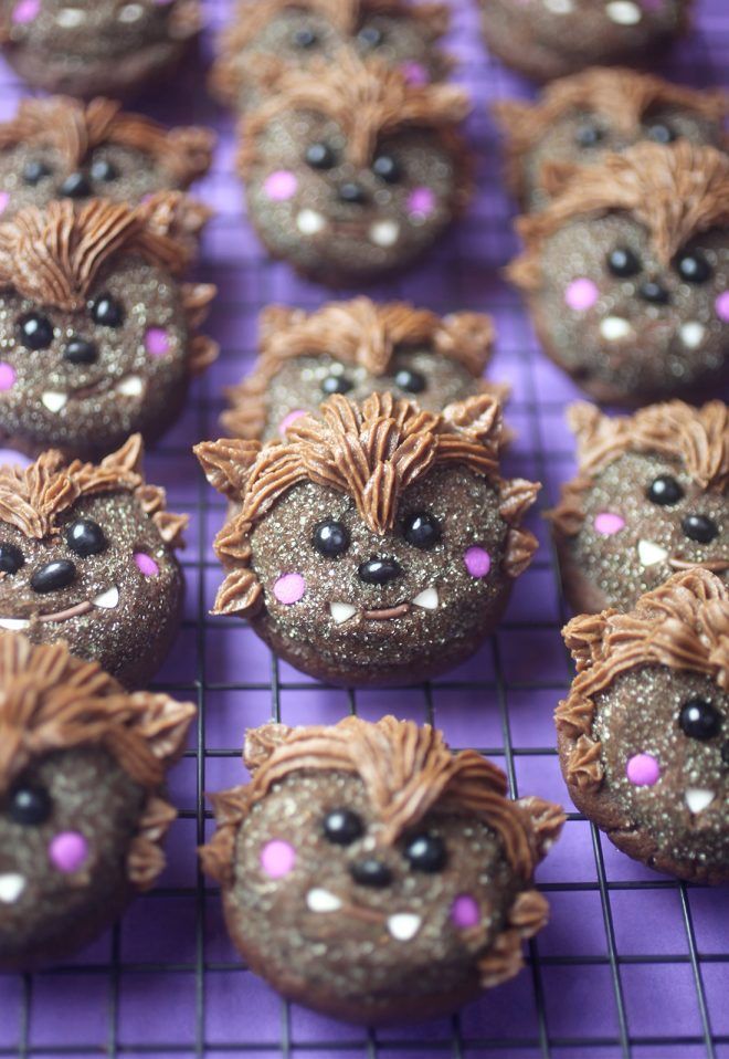 chocolate cupcakes decorated like hedgehogs with sprinkles on a cooling rack