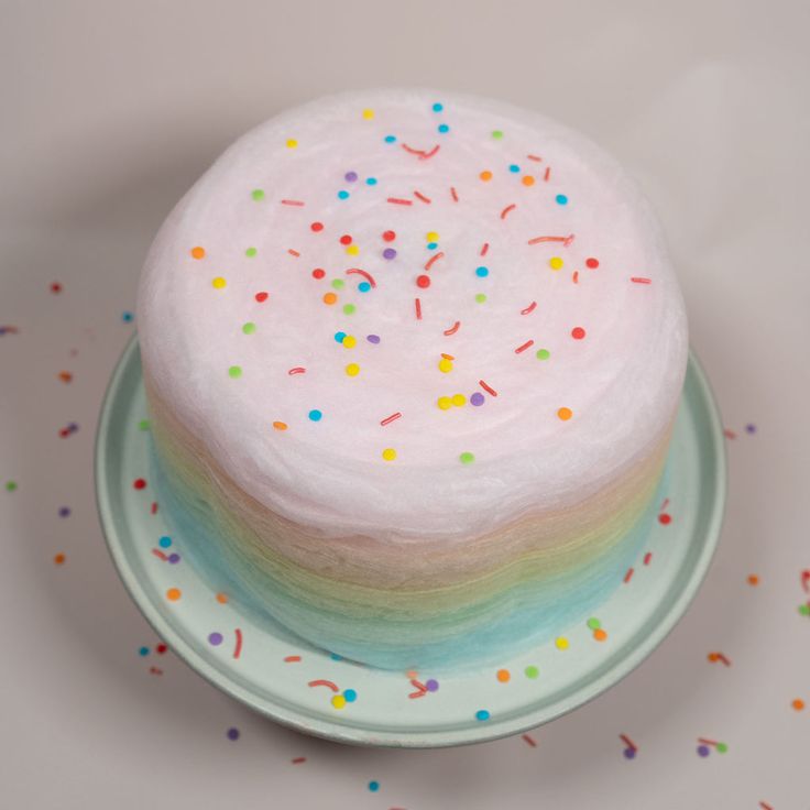 a white cake with sprinkles on a plate