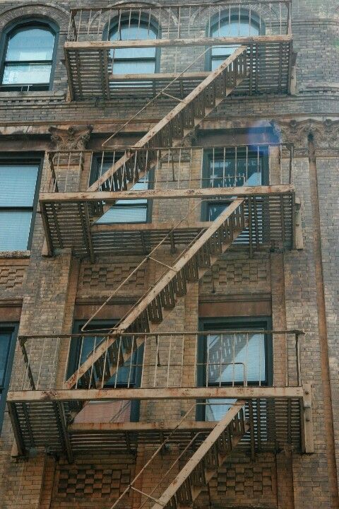 an old brick building with fire escape stairs