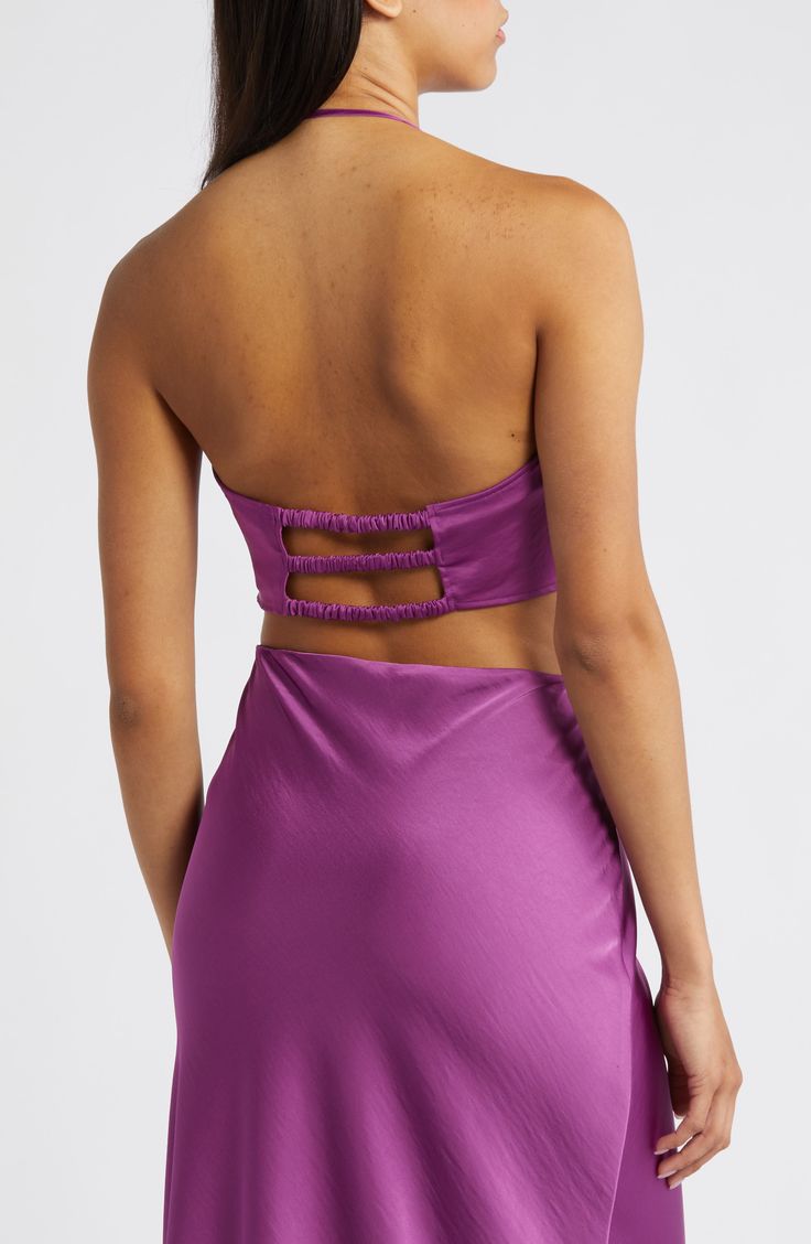 Capture glances in an alluring halter top designed with an open back and deep neckline highlighted by a polished O-ring. 15" length Halter neck Back elastic straps 100% polyester Machine wash, dry flat Imported Fitted Satin Halter Top For Date Night, Glamorous Backless Halter Top For Date Night, Backless Halter Top With Built-in Bra For Party, Glamorous Halter Neck Top For Date Night, Evening Halter Neck Crop Top With Tie Back, Elegant Strappy Back Halter Top For Party, Glamorous Backless Tube Top For Night Out, Evening Halter Neck Fitted Tube Top, Satin Halter Neck Crop Top For Night Out