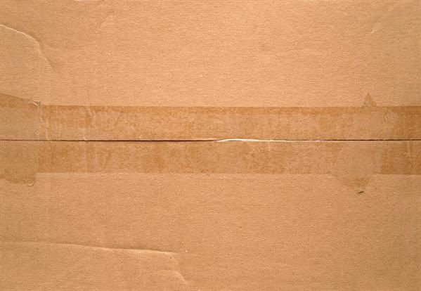 an open brown cardboard box with some tape on the bottom and one line drawn across it