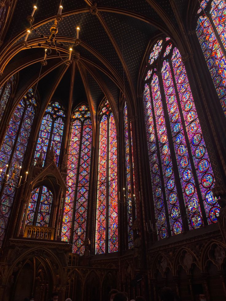 the inside of a cathedral with many stained glass windows