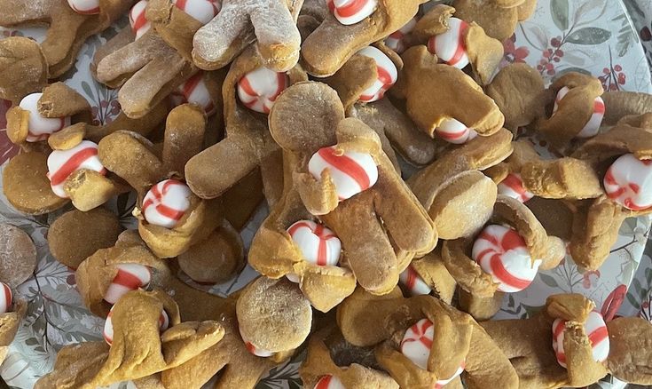 a pile of teddy bears with candy canes on them