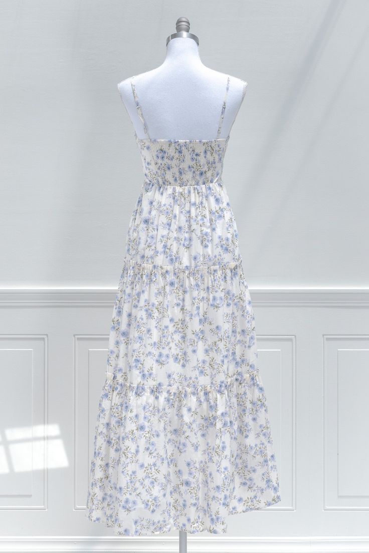 A charming dress for your next occasion, the La Belle Revière midi dress features a beautiful periwinkle blue floral print, smocked elastic back, an a-line skirt with ruffled tiers, a button-up front, and a sweetheart neckline with keyhole detail. . Details: S: Bust 32"-34", Waist 26"-30", Length 53" M: Bust 34"-36", Waist 28"-32", Length 53.5" L: Bust 36"-38", Waist 30"-34", Length 54" Length Measured from Top of Bust Length from Waist to Hem: 39" Lined Material: 80% Polyester, 20% Cotton Impor Spring Brunch Smocked Dress With Tiered Skirt, Spring Ruched Midi Dress With Ruffled Straps, Spring Midi Dress With Ruched Ruffled Straps, Tiered Smock Maxi Dress For Brunch, Spring Floral Dress With Smocked Bodice For Daywear, Spring Summer Smocked Dress With Tiered Skirt, Spring Smocked Dress With Tiered Skirt, Smocked Tiered Skirt Dresses For Garden Party, Ruffled Smocked Dress For Garden Party In Spring