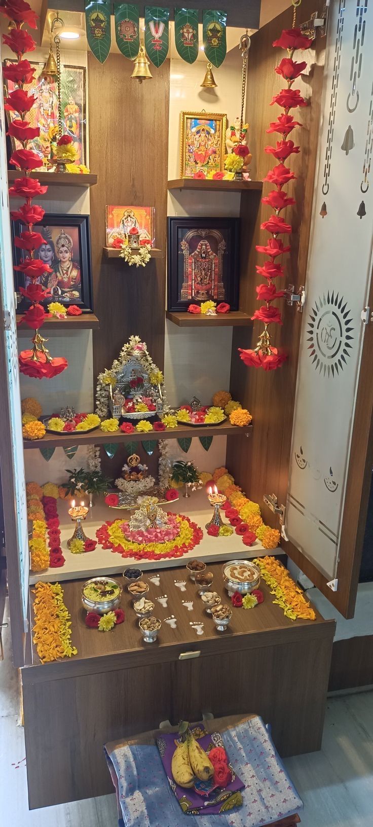 a table with many items on it in front of some shelves filled with pictures and decorations