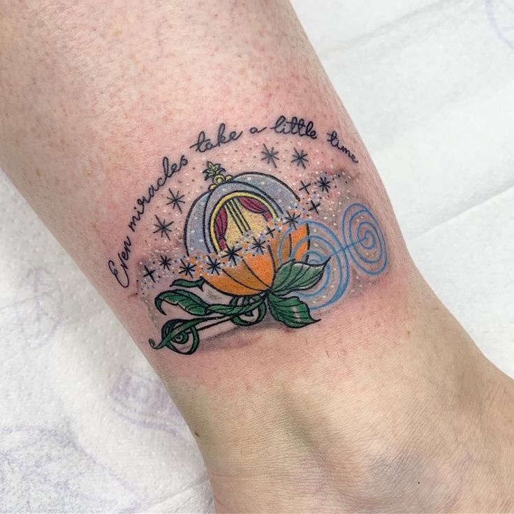 a tattoo on the foot of a person with a rose and stars around it's center