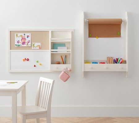 a child's desk and chair in front of a white wall with bookshelves