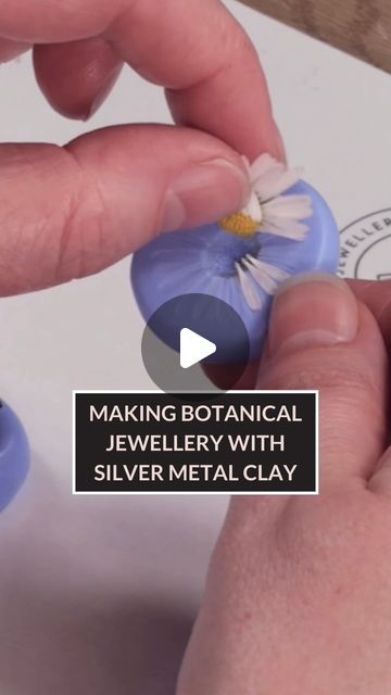 a person is making a flower with silver metal clay on a piece of paper that says, making botanical jewelry with silver metal clay