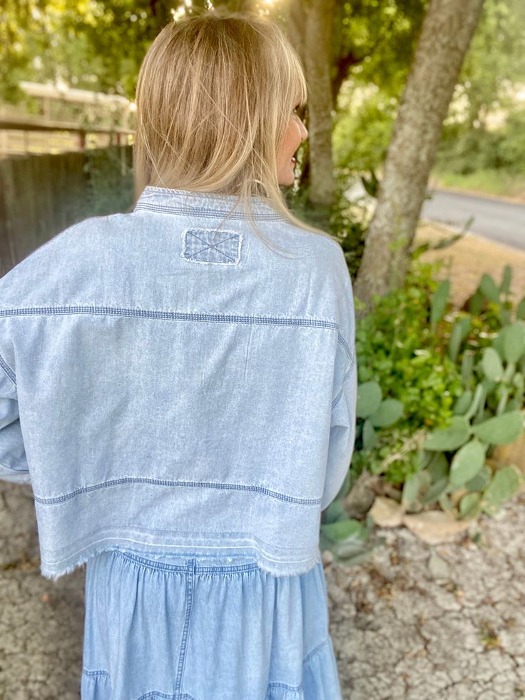 Unleash your playful side with The Dandelion denim top. Its boxy style and deep v neck add a touch of whimsy, while the pleated sleeves and side slits offer a unique twist. Made from light weight denim, this top is perfect for breezy days. This blouse hits at the hips and runs on the roomier relaxed side. model is shown wearing a small and is a 2/4, 5'6" tall and 34C bust s-2/4/6 m-6/8/10 l-10/12/14 90/10 cotton/poly Relaxed Fit Light Wash Denim Top For Day Out, Trendy Denim Tops For Day Out, Chic Tops With Frayed Hem And Relaxed Fit, Chic Relaxed Fit Top With Frayed Hem, Light Wash Cotton Denim Jacket For Day Out, Short Sleeve Denim Top For Spring Day Out, Spring Short Sleeve Denim Top For Day Out, Trendy Medium Wash Tops For Spring, Relaxed Fit Washed Tencel Tops