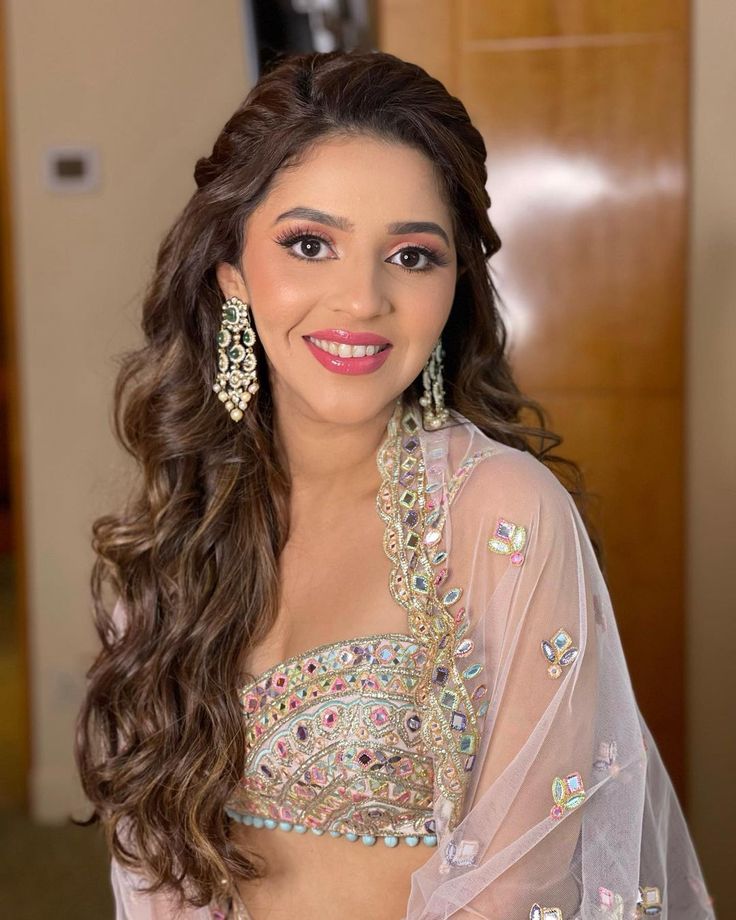 a woman with long hair wearing a dress and earrings