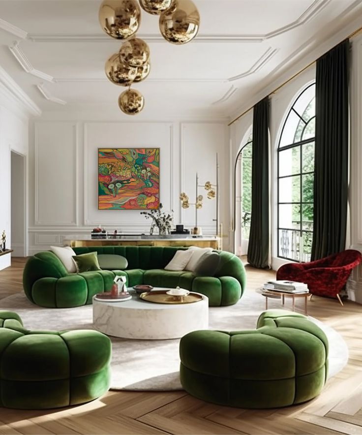 a living room filled with green couches and round tables on top of hard wood floors