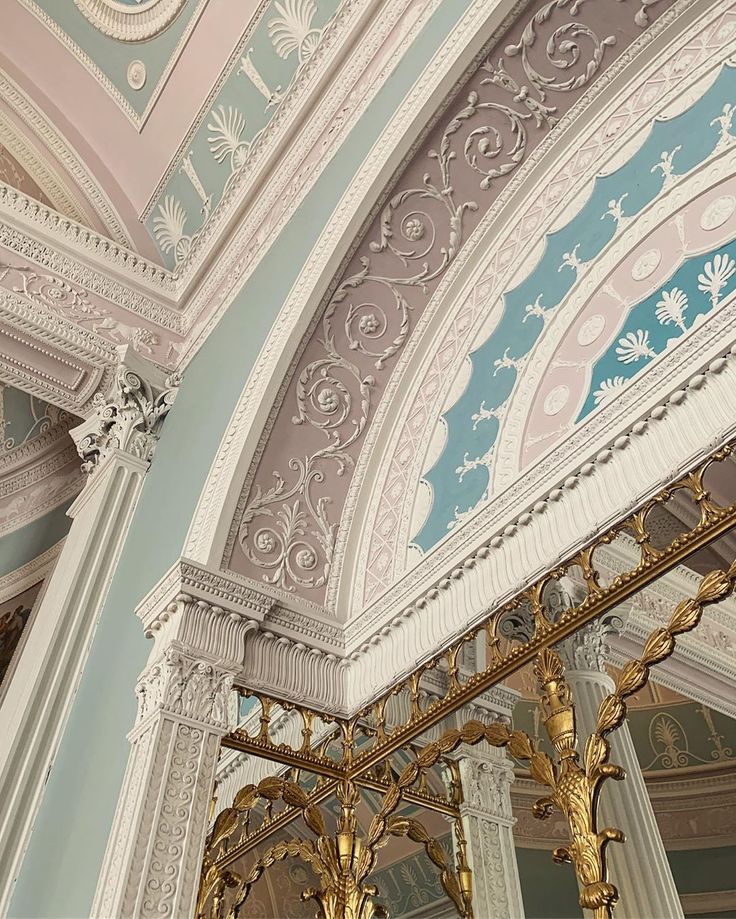 an ornately decorated building with gold and blue details on the ceiling, along with chandeliers