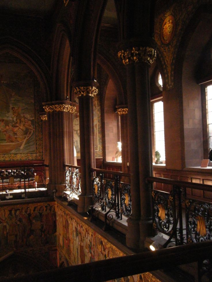 an ornate building with stained glass windows and wrought iron railings