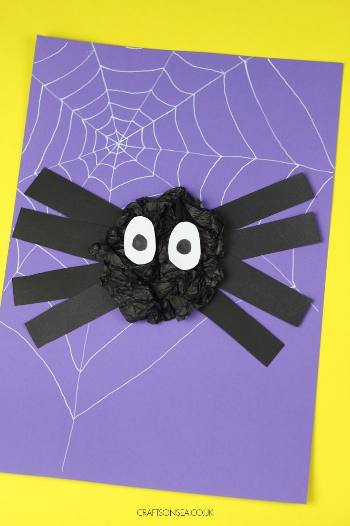 a spider made out of black paper with googly eyes