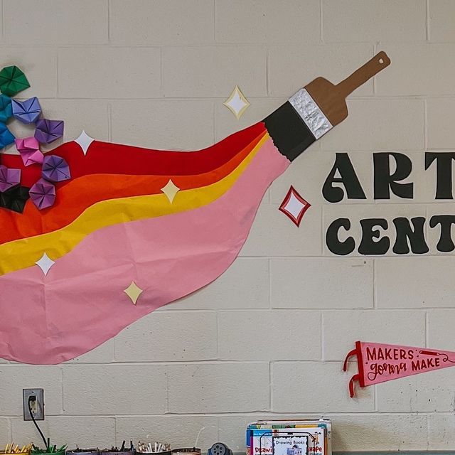 an art center with paper and craft supplies on the wall, along with other items