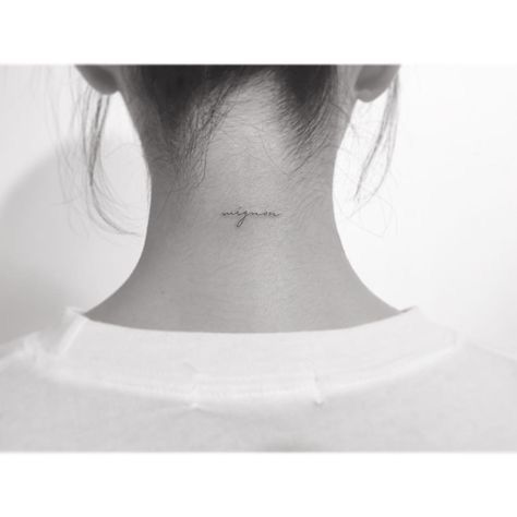 a woman's back neck with the word love on her left side, and an inscription