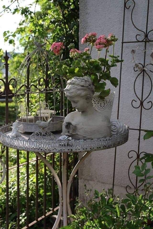 a small statue sitting on top of a metal table