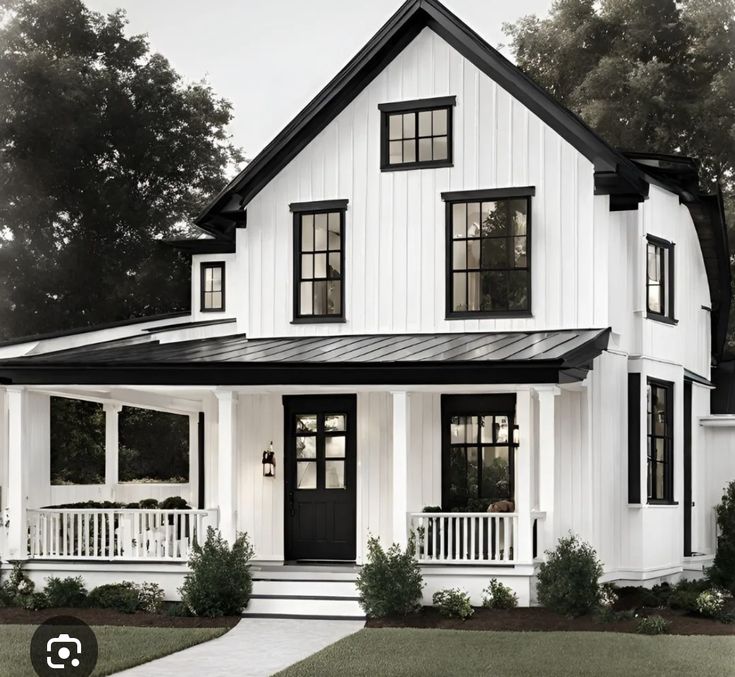 a white house with black trim on the front and side doors, windows, and porches