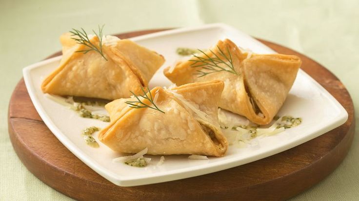 three small pastries on a white plate