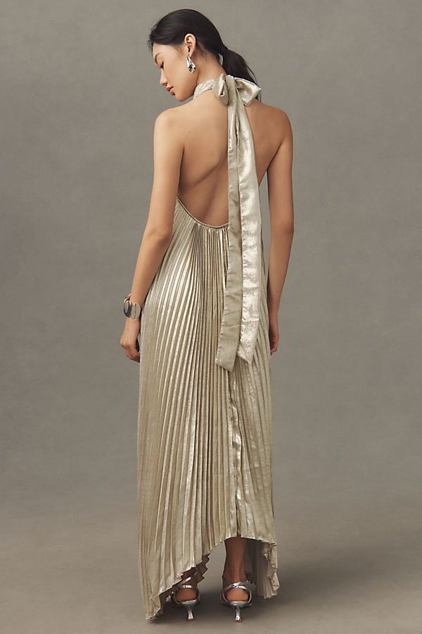 Embracing a flair for drama & grandeur, the Opera plays carefully with modern elegance. Featuring a high neckline, tie back halter and asymmetrical silhouette, this stunning billowing pleat full-length dress will transform you for an evening to remember. | Opera Halter Cutout Maxi Gown by L'IDÉE in Gold, Women's, Size: 10, Polyester/Tin at Anthropologie Gown Gold, Halter Gown, Bridal Shower Dress, Exclusive Dress, Full Length Dress, Dress Home, Maxi Gowns, Denim Design, Gold Dress