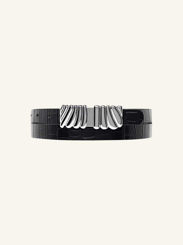 Add a luxurious statement to your everyday look with the Selene Belt. Made with 100% leather with a stone detail and a beautiful custom silver statement buckle. Item Details: Metal buckle detail Adjustment: 8 holes Strap Width: 20mm Genuine Leather Sizing: XS/S: 32'': Depending on where you like your belt to sit, fits jean size 24, 25, 26, 27. M/L: 37'': Depending on where you like your belt to sit, fits jean size 27, 28, 29, 30. Measurement is taken from the buckle point to the third hole. Gift Wrapping Available Each piece comes in its own luxury Love Isabelle Packaging with one gift box per order. Designer Silver Belts, Modern Belts With Palladium Hardware For Business, Luxury Leather Belt Buckles For Evening, Elegant Silver Belts For Business, Modern Formal Belt Buckles With Palladium Hardware, Luxury Silver Belt Buckles For Business, Elegant Silver Belt Buckles For Business, Designer Silver Leather Belt, Luxury Formal Belt With Metal Pin Buckle