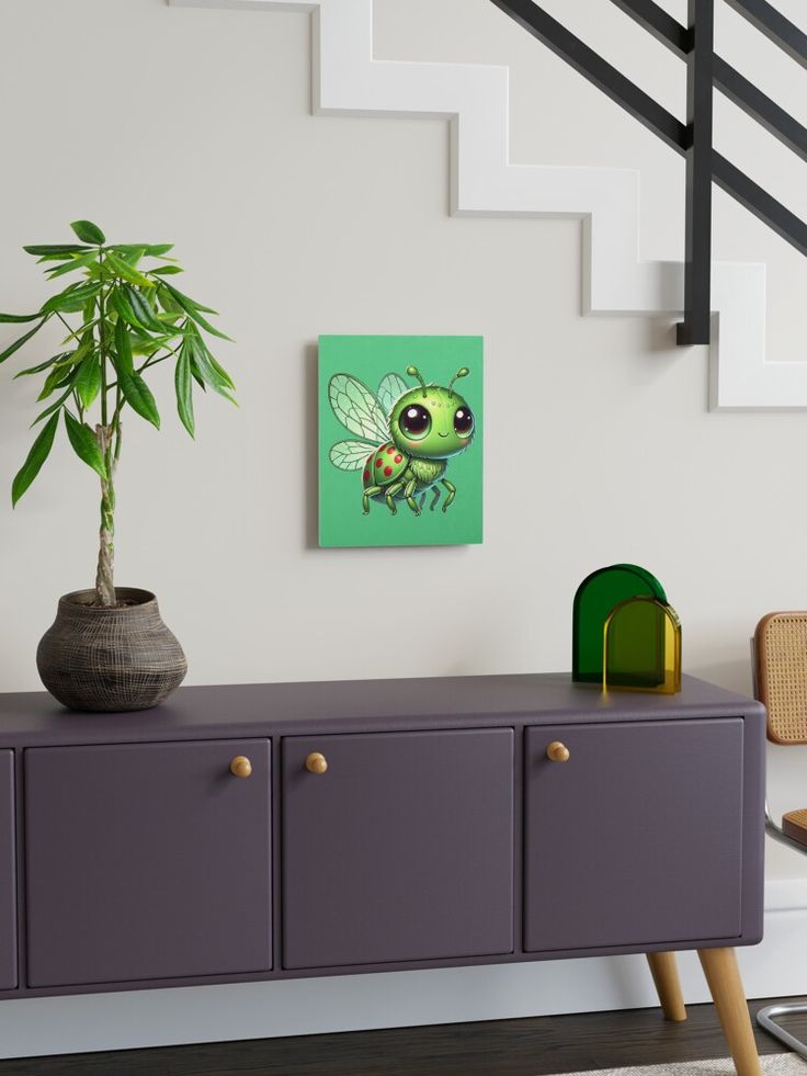 a plant sitting on top of a purple cabinet