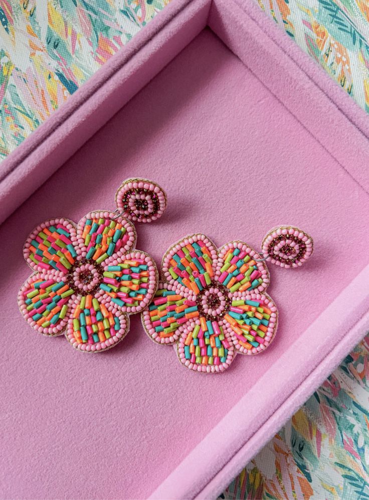 Add a pop of color to your summer wardrobe with our Flower Power Earrings. These beaded earrings exude a vibrant energy, perfect for a fun and lively look. Elevate any outfit with these must-have accessories. Measures : 3" Fun Multicolor Flower Earrings, Playful Handmade Multicolor Flower Earrings, Flower-shaped Earrings With Colorful Beads For Party, Multicolor Flower-shaped Earrings With Colorful Beads, Elegant Multicolor Flower-shaped Earrings, Artisan Earrings, Summer Wardrobe, 9 And 10, Flower Power