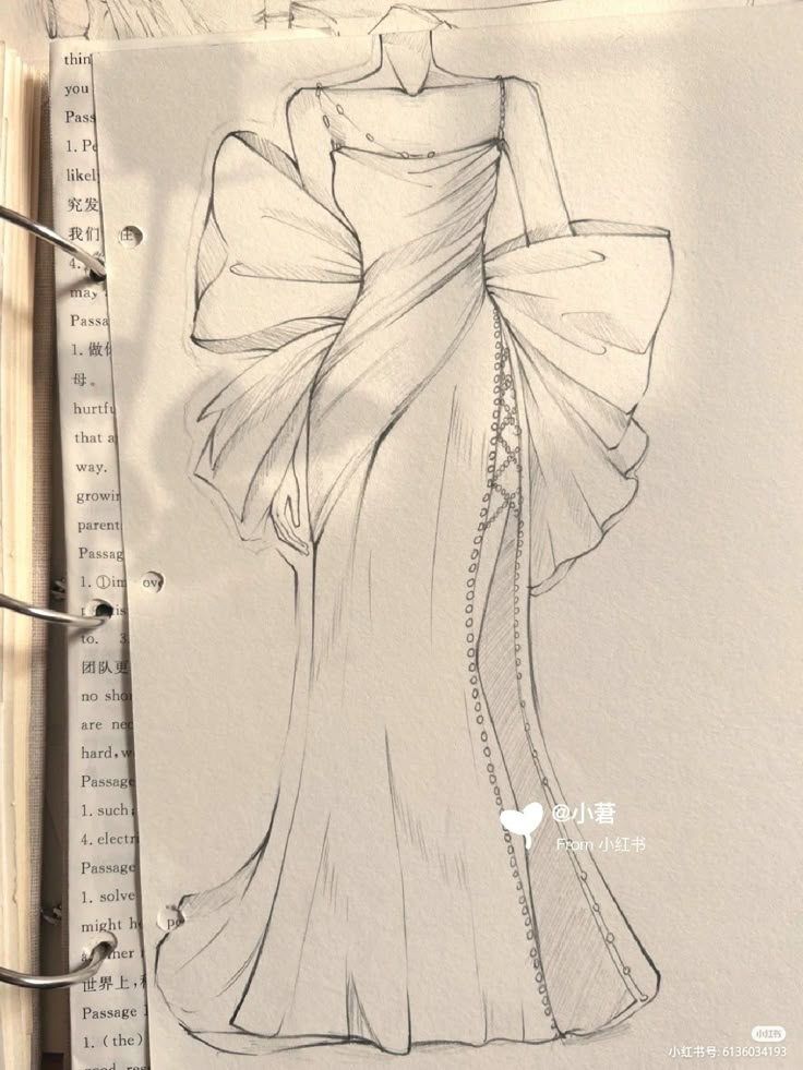 a drawing of a woman's dress on top of a piece of paper next to a pen