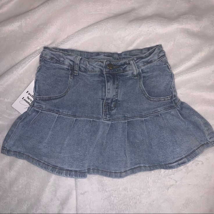 Comfy And Stretchy Jean Skirt With Shorts Built In. Never Worn New With Tags! So Cute Goes With Every Outfit Size Small Trendy Non-stretch Mini Skirt, Trendy High Waist Pleated Skirt, Trendy High-waist Pleated Skirt, Cute Denim Blue Skirt, High Waist Denim Blue Skirt For Day Out, Casual Non-stretch Skirt Bottoms, High-waist Denim Blue Skirt For Day Out, Casual High Waist Ruffled Denim Skirt, Casual Non-stretch Lined Skort