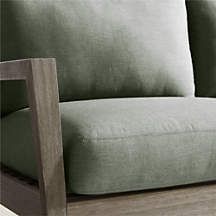 a green couch sitting on top of a wooden floor