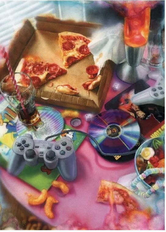 a table topped with pizza and video game controllers