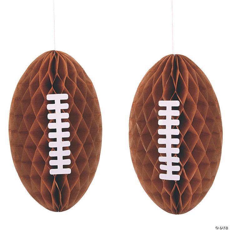 two brown paper balls with white footballs hanging from the top one is made to look like honeycombs