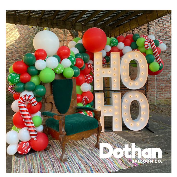 the balloon arch is decorated with candy canes and candies for an outdoor holiday party