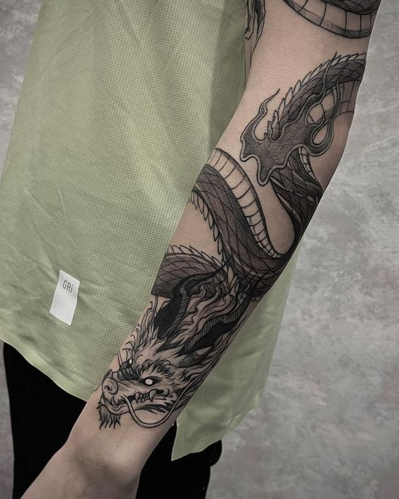 a man with a dragon tattoo on his arm