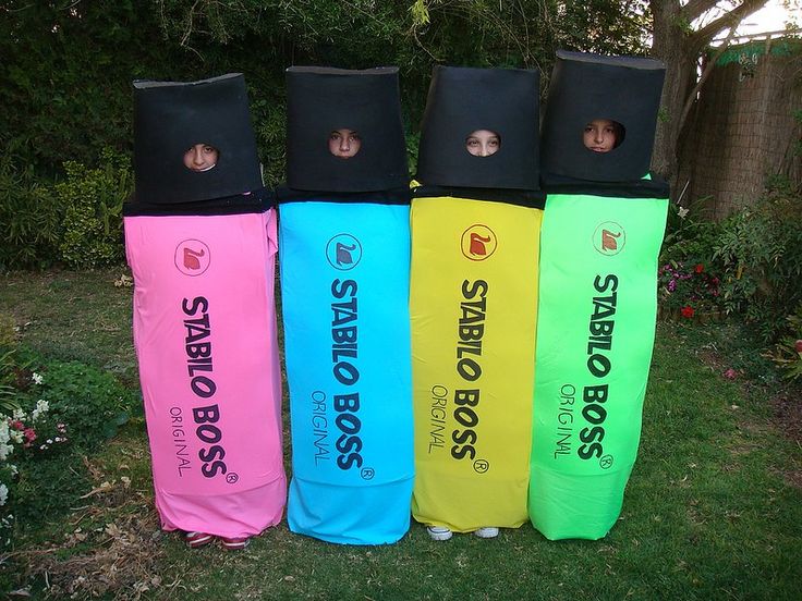 four children's bean bag costumes are lined up in a row on the grass