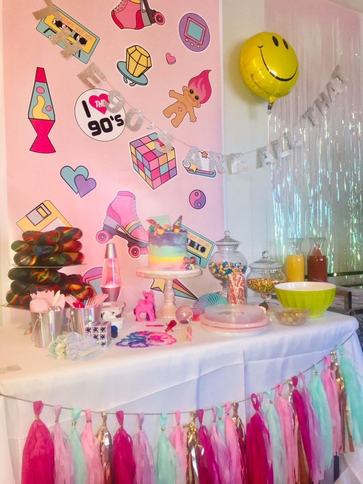 a party table with decorations and balloons