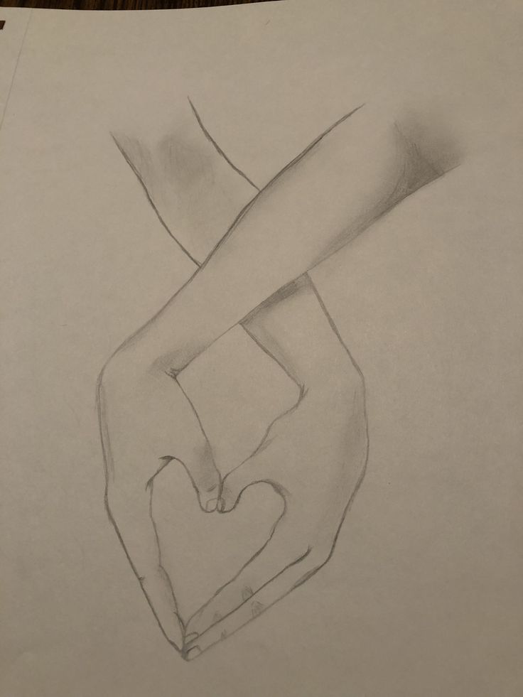 a pencil drawing of a hand holding a heart